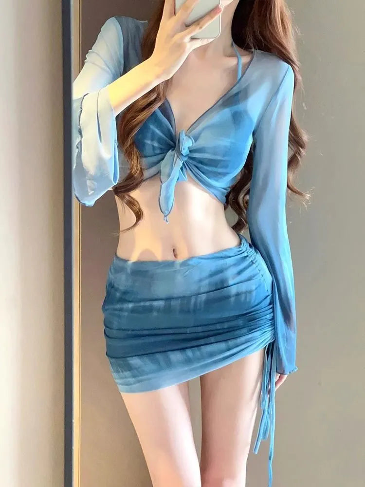 Women's blue high-waist four-piece bikini set with shirt, bra, underwear, and skirt on a mannequin