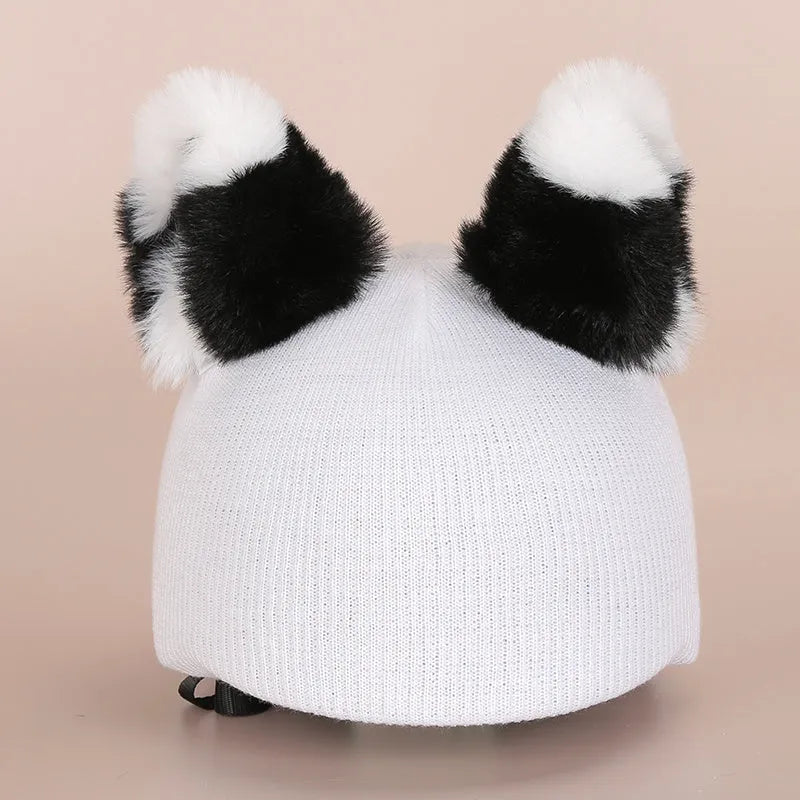 Plush fabric ski helmet decoration hat featuring a colourful cartoon design, shown on a helmet.