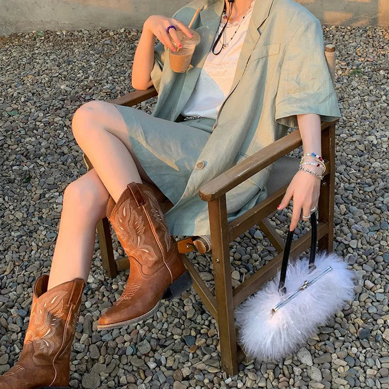 Brown embroidered women's mid-calf Martin boots with leather lining and a low square heel.