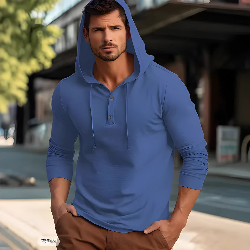 Man wearing a dark blue cotton pullover hoodie with long sleeves, showing front view.