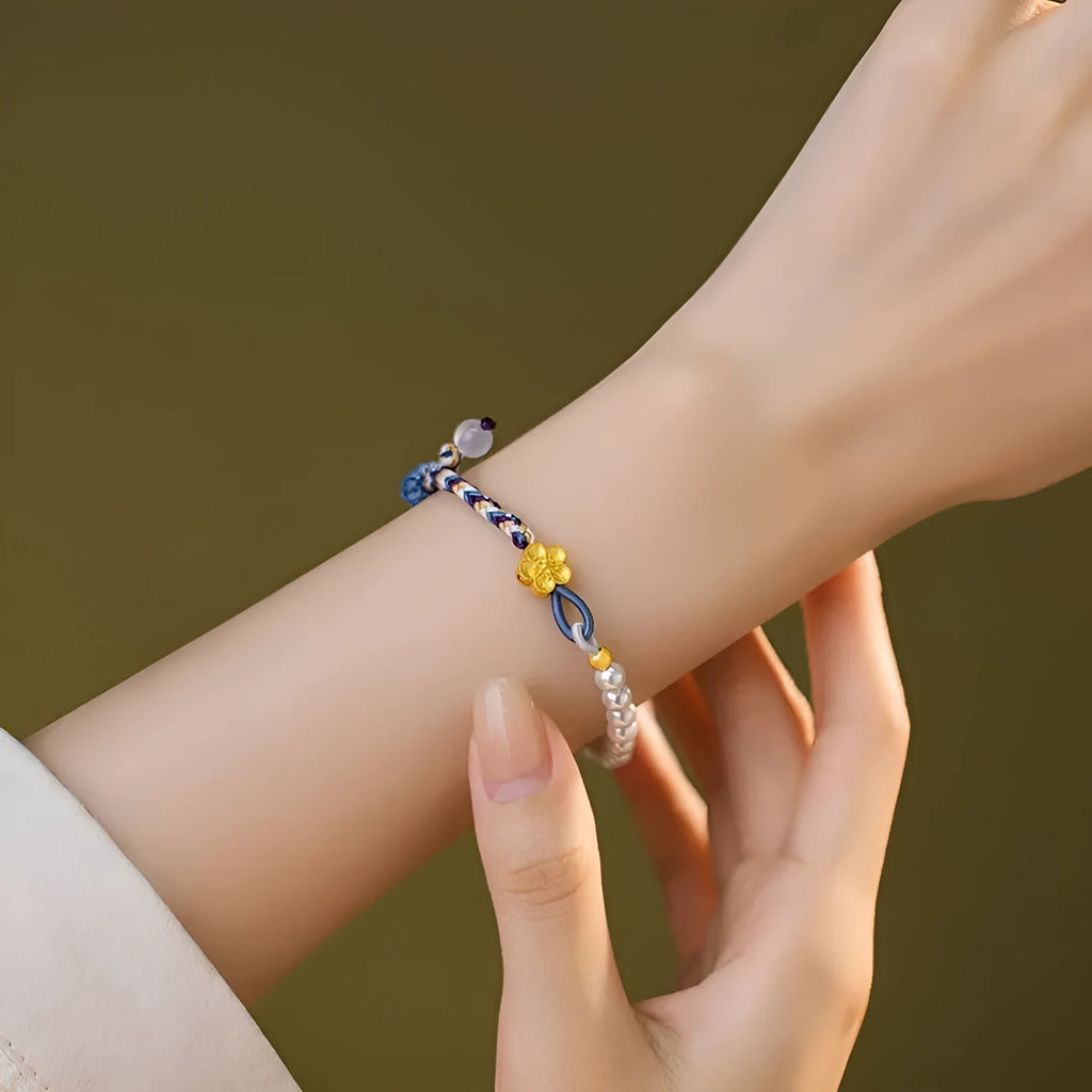 Peach-coloured Chinese flower weaving carrying strap bracelet with pearl accents on cord material