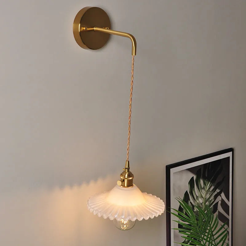 Retro brass bedside lotus wall lamp with glass shade in transparent finish, copper body, 22cm diameter