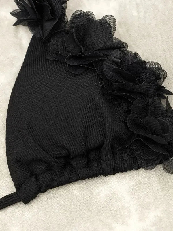 Black women's two-piece polyester swimsuit set with top and shorts on a mannequin