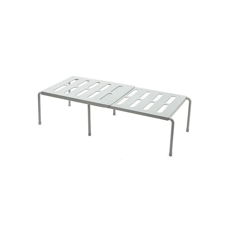 White telescopic plastic kitchen rack extended to 69cm height on kitchen countertop