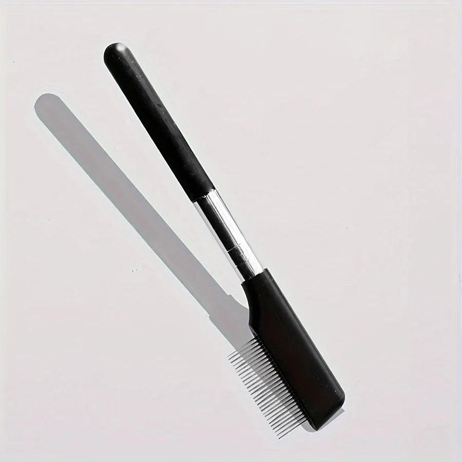 Black dual-ended pet grooming brush with soft brush and comb on a white background.