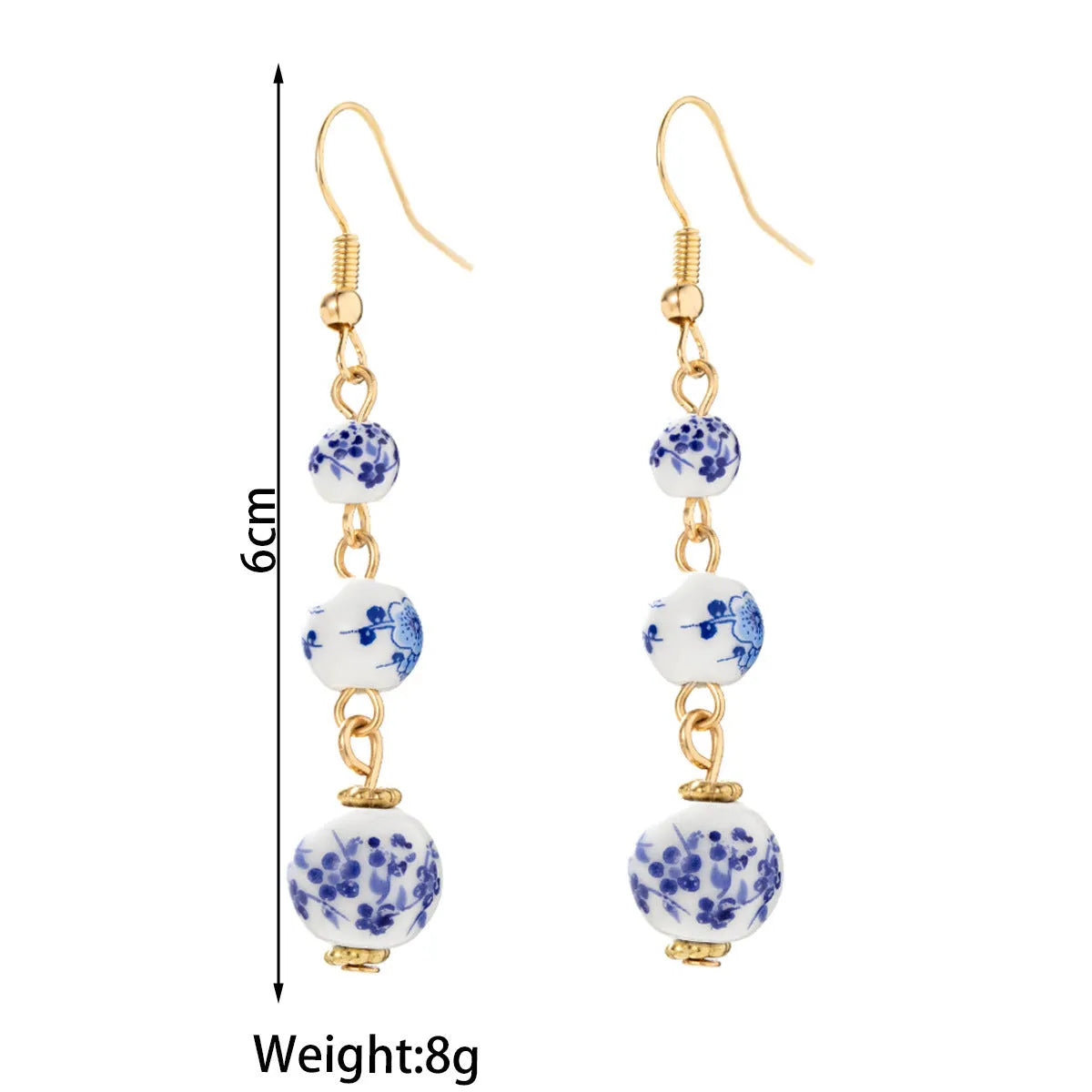 Long retro earrings with blue and white porcelain-coloured ceramic beads and geometric alloy details.