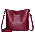Women's soft leather bucket shoulder bag in black with minimalist design and interior phone pocket