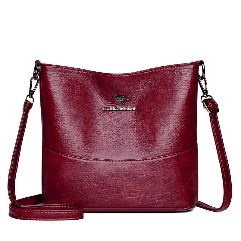 Women's soft leather bucket shoulder bag in black with minimalist design and interior phone pocket