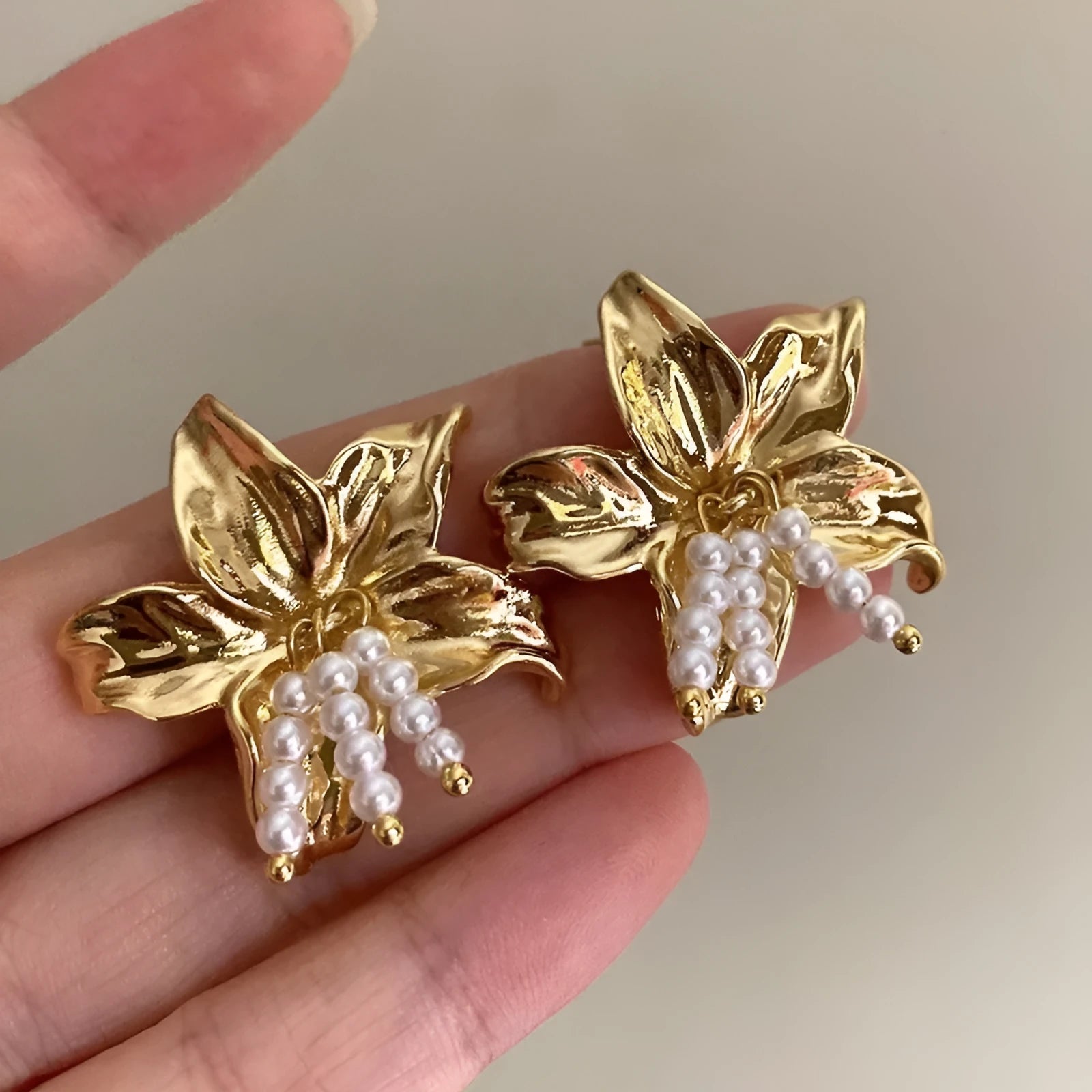 Gold floral pearl earrings with exaggerated design and Seiko-treated metal construction