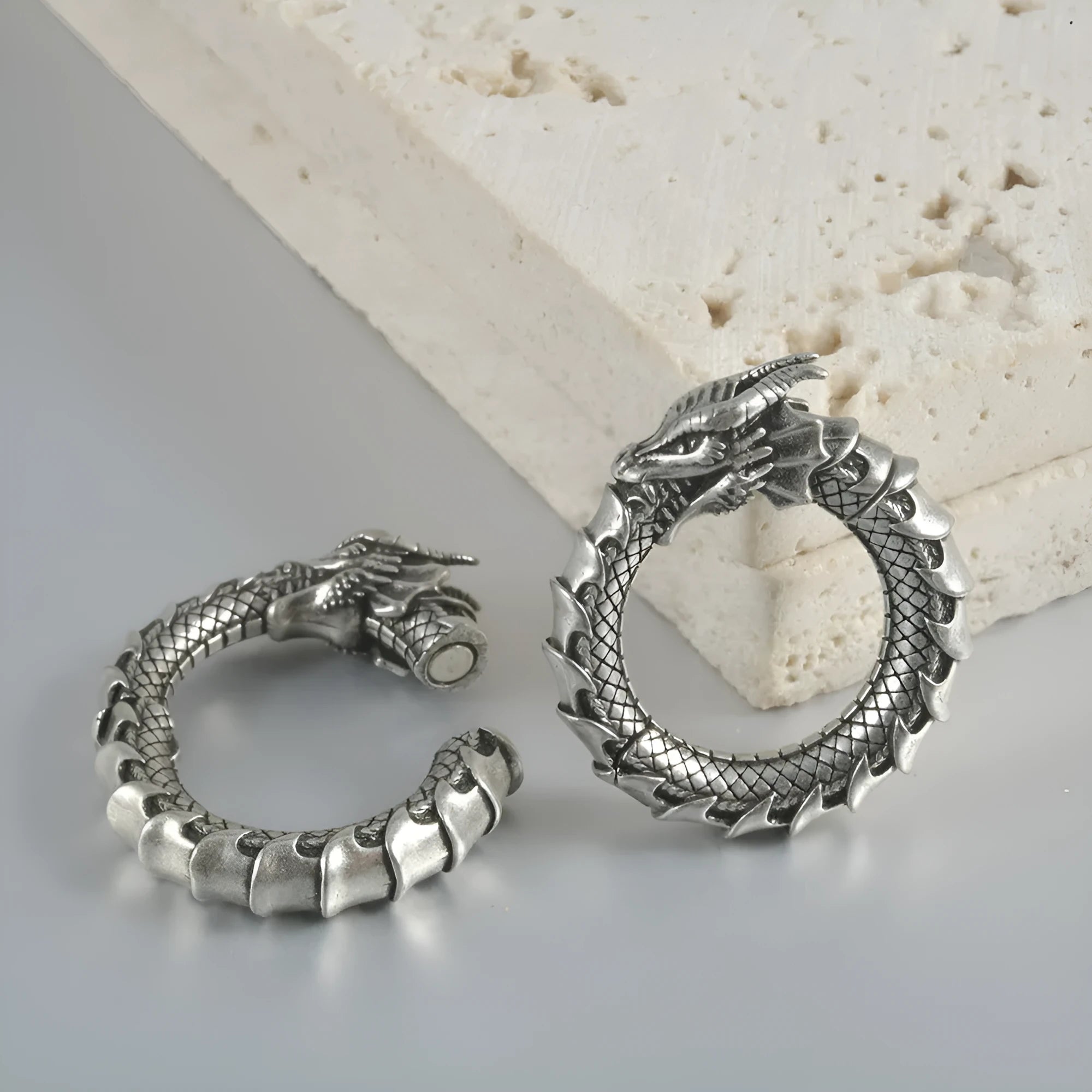 Large geometric dragon earrings with antique silver finish and hollow-out design on white background