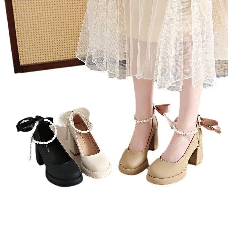 Women's beige Mary Jane shoes with ankle strap buckle, chunky low heel, pearl detail and round toe.