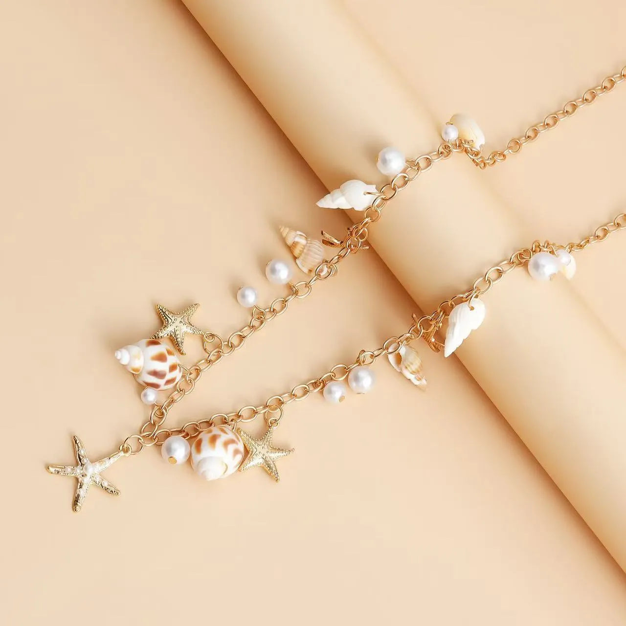 Women's alloy star-design waist chain and matching bracelet jewellery set on a white background.