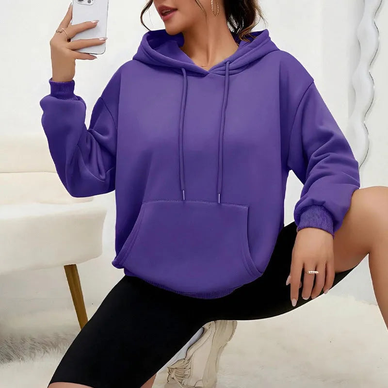 Women's loose grey drawstring pocket sweatshirt with long sleeves on a hanger