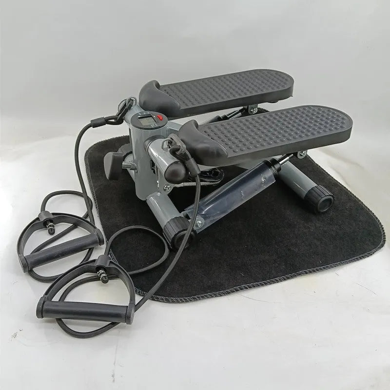 Silver grey household mini treadmill waist slimming machine with hydraulic resistance system.