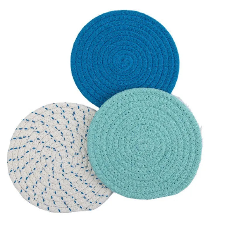 Three round cotton cord coasters in blue colour showing 18cm diameter measurement