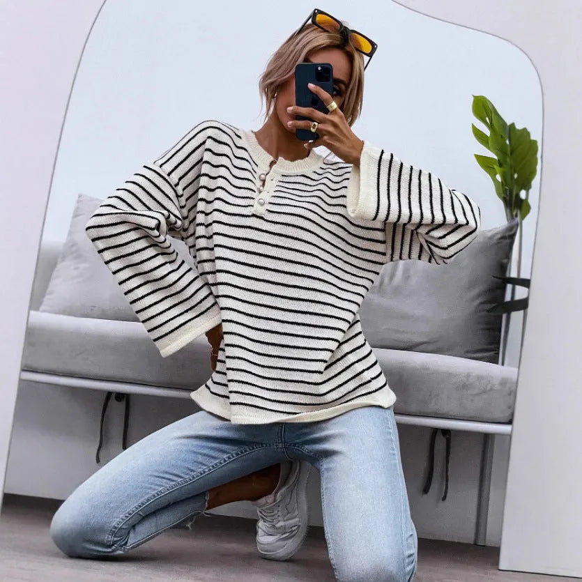 Women's black striped casual top with drop-shoulder sleeves and button details