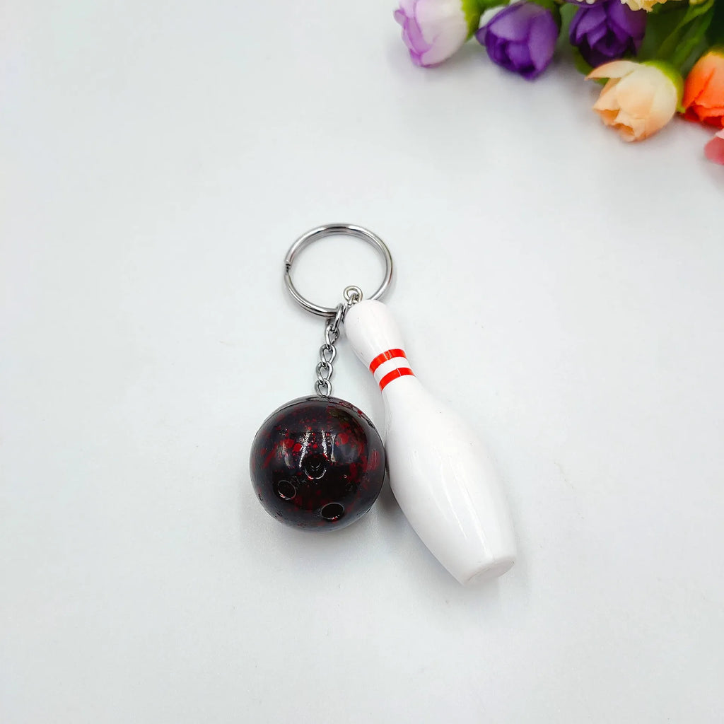 Mini bowling ball keychain pendant in PVC metal available in four colours: dark red, blue, purple, green