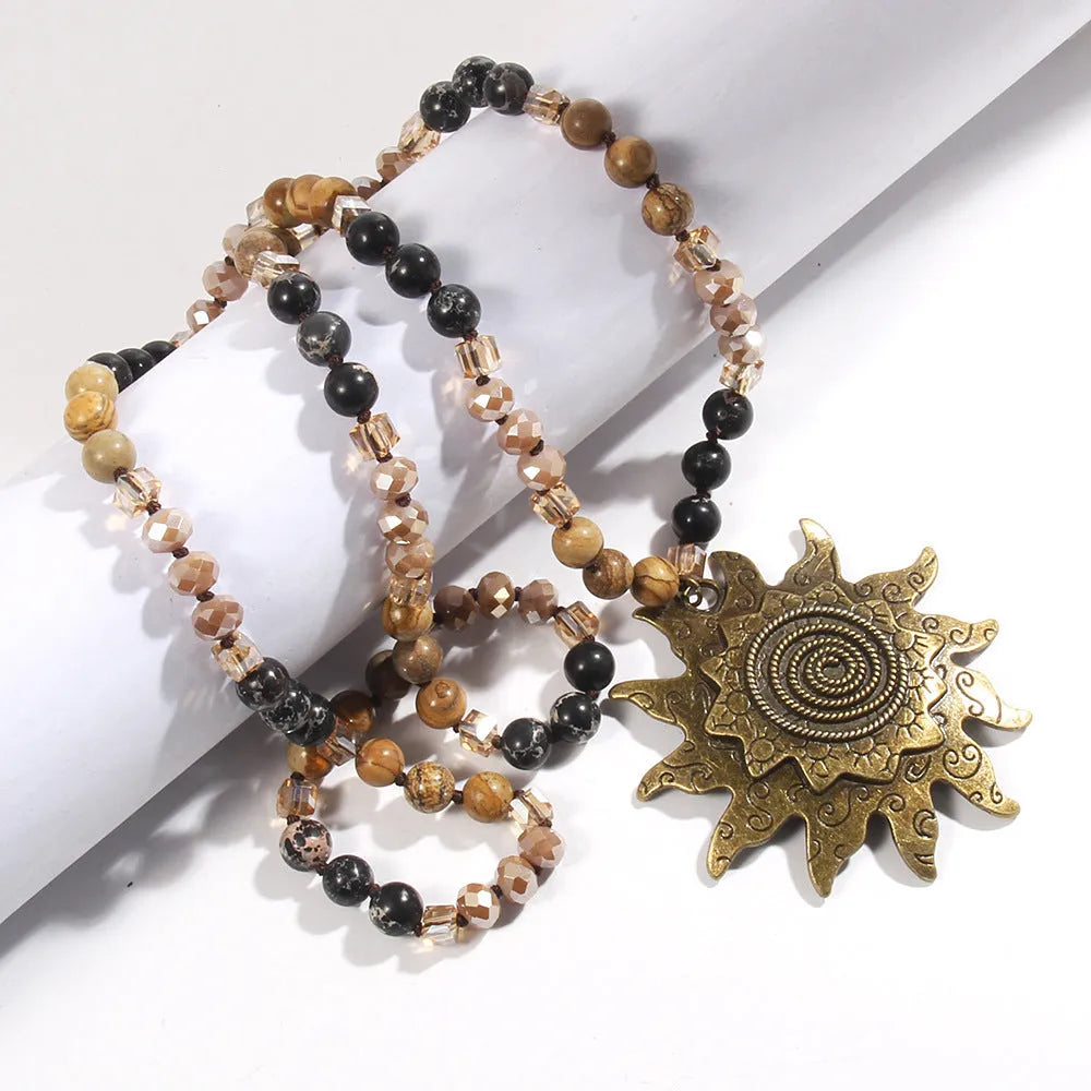 Natural stone beaded necklace with ancient cyan sun pendant and glass knotted chain in black or dark brown.