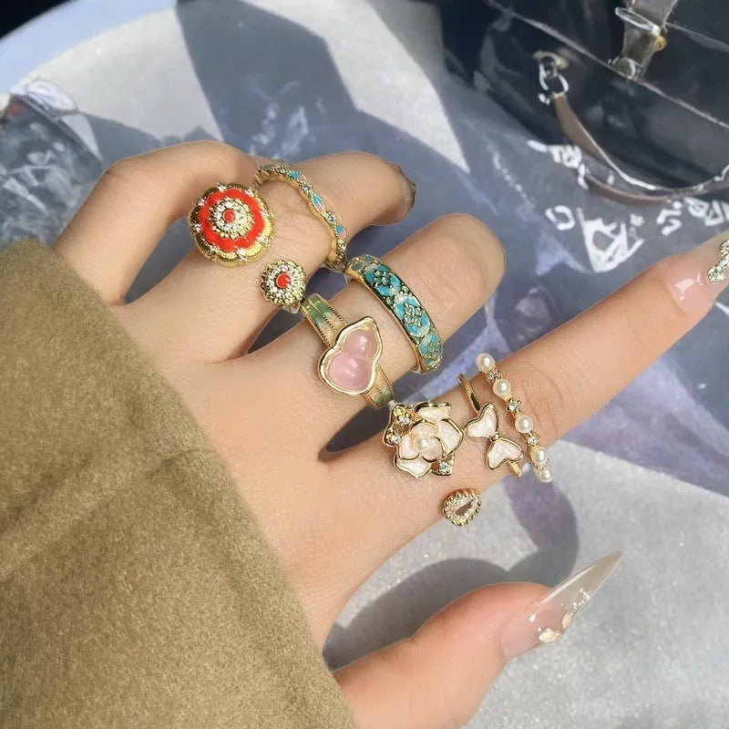 Adjustable copper ring with vintage gourd, flower and bow designs featuring inlaid zircon accents