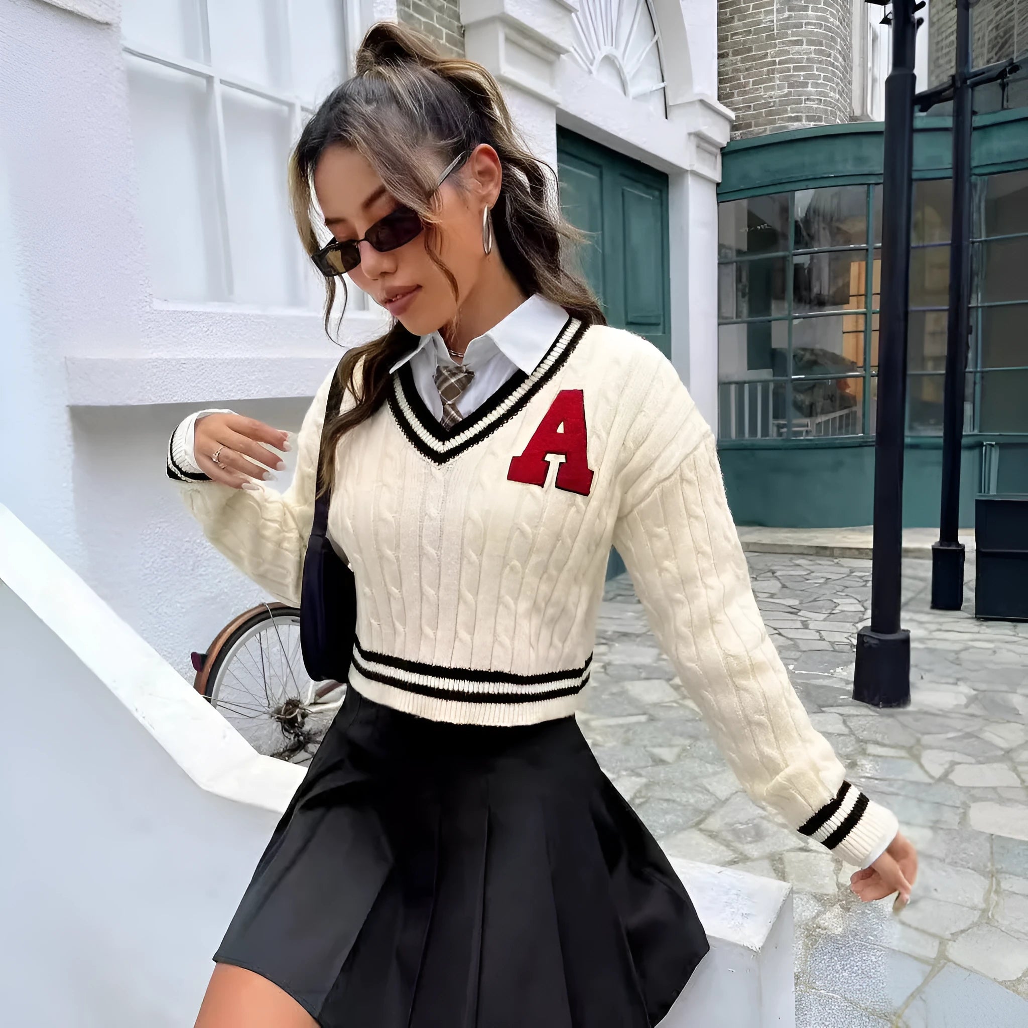 V-neck creamy white knitted shirt with slim stripes and patch detail on model