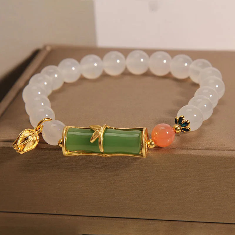 Close-up of a white agate and jade bamboo joint bracelet for women, traditional Chinese style.