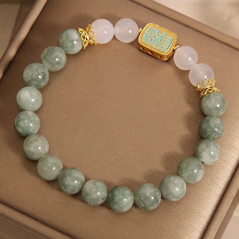 Women's oil green emerald crystal bracelet showing five scripture elements on wrist