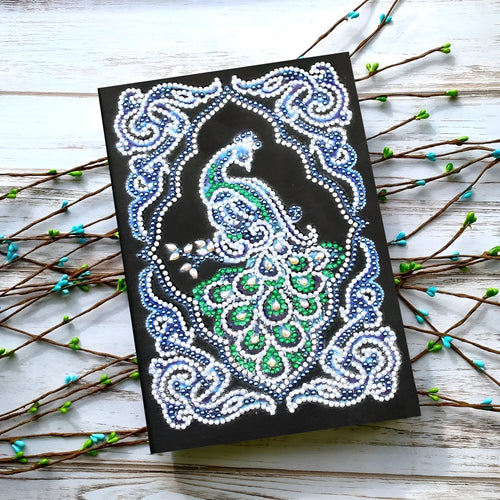 Black A5 diamond painting notebook with peacock design showing shaped and bright drills
