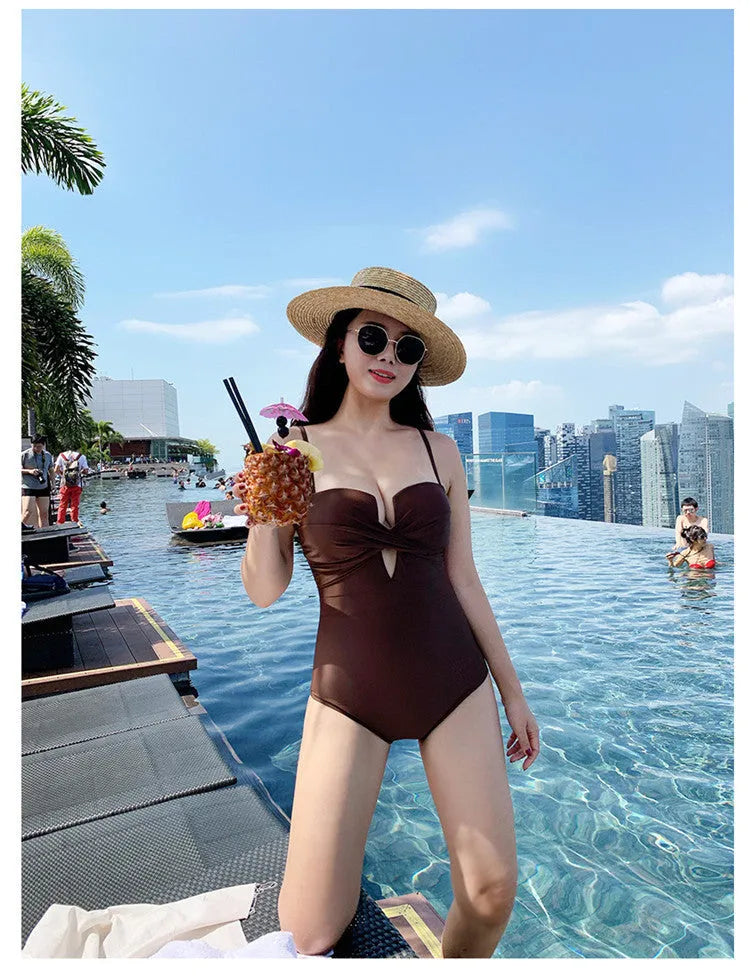 Brown one-piece swimsuit with spaghetti straps and push-up design on a mannequin