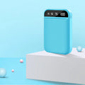 Compact rectangular power bank with multiple USB ports shown in black, blue, pink, and white colour options