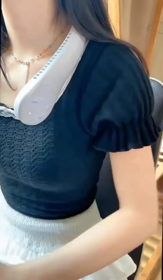 Pink bladeless neck fan hanging around neck with USB charging cable