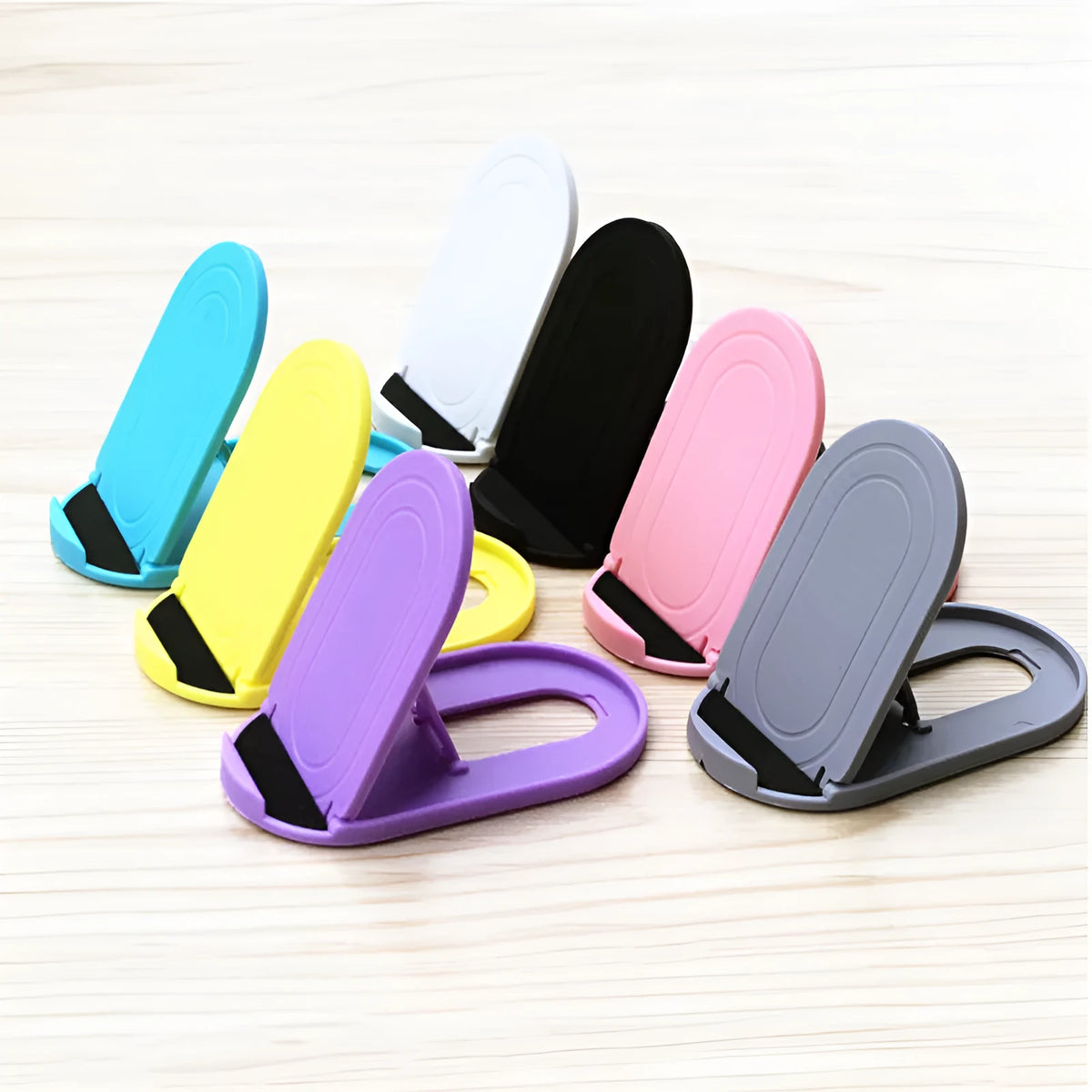 Plastic mobile phone stand in six colour options showing bracket design for desk use