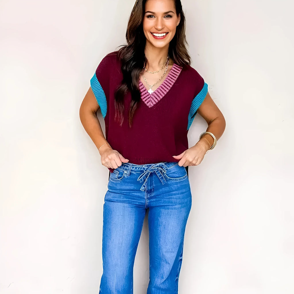 Burgundy loose sweater with contrast trim, V-neck, and cuffed short sleeves.