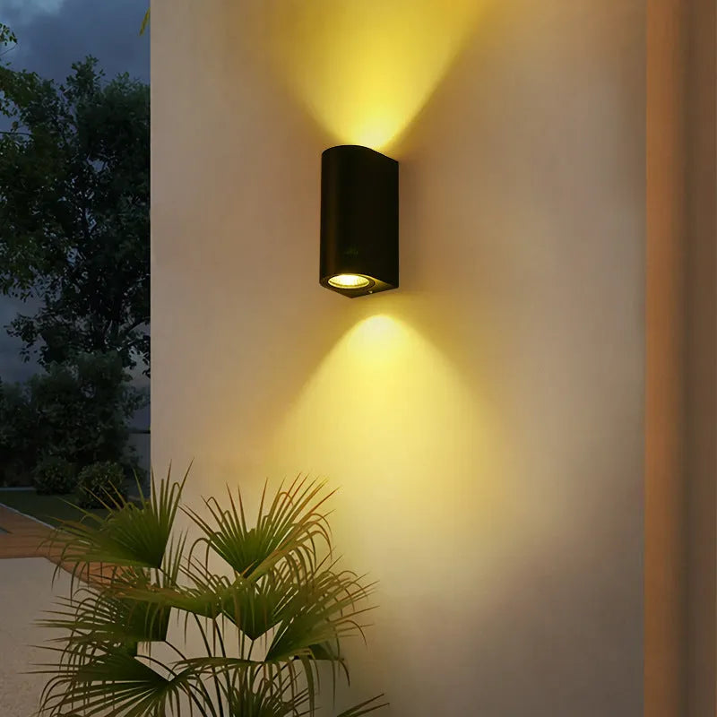 Simple modern outdoor waterproof LED wall lamp in black aluminium with glass panel for garden or patio