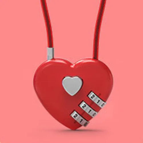 Heart-shaped wire rope lock in various colours with a steel cable, shown securing a bicycle helmet.