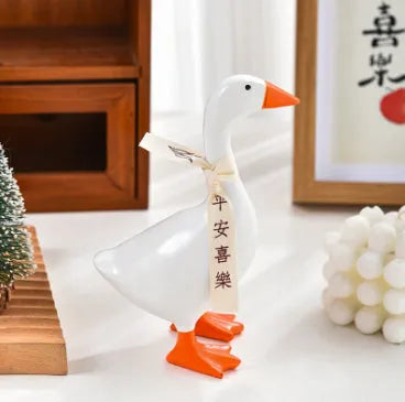 White simulated duck magnetic resin ornament on a fridge door