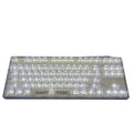 Transparent plastic keyboard key caps arranged as complete 132-key set for mechanical keyboard replacement