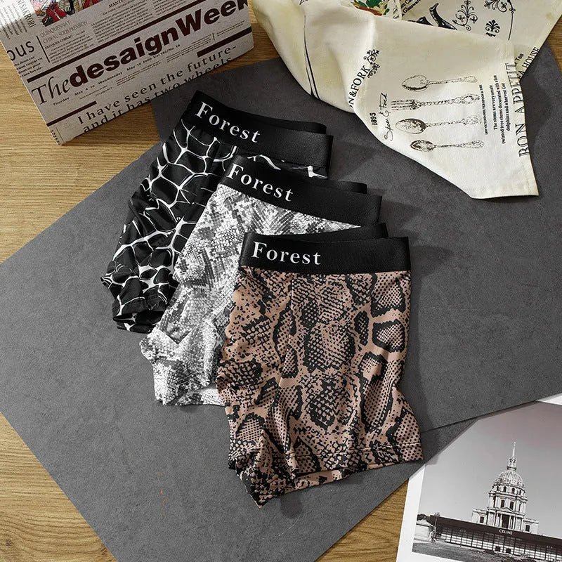 Men's thin loose polyester boxer shorts in black on grey background showing mid-waist design