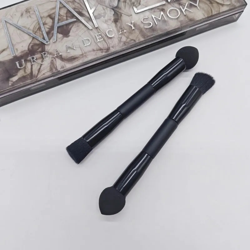 Double-headed makeup brush with black miter sponge and artificial fibre bristles on wooden handle