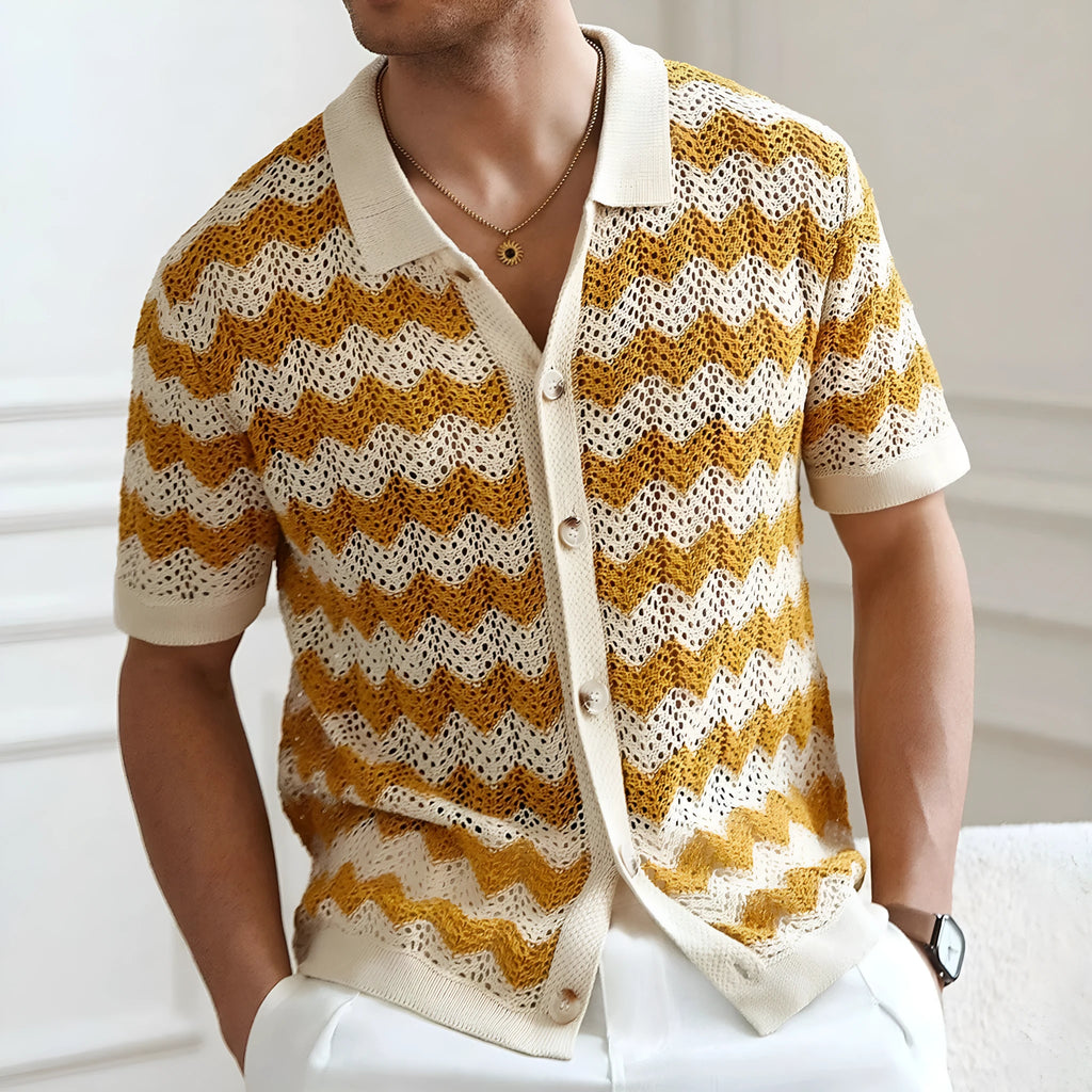 Short-sleeved yellow corrugated knit sweater with flocking detail on a hanger.