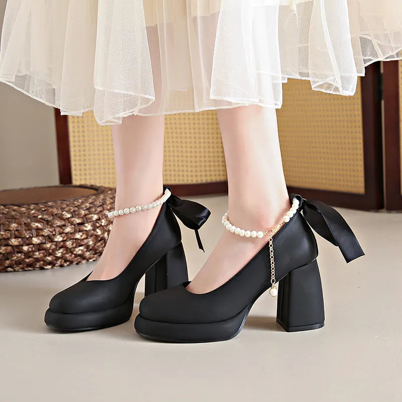 Women's beige Mary Jane shoes with ankle strap buckle, chunky low heel, pearl detail and round toe.