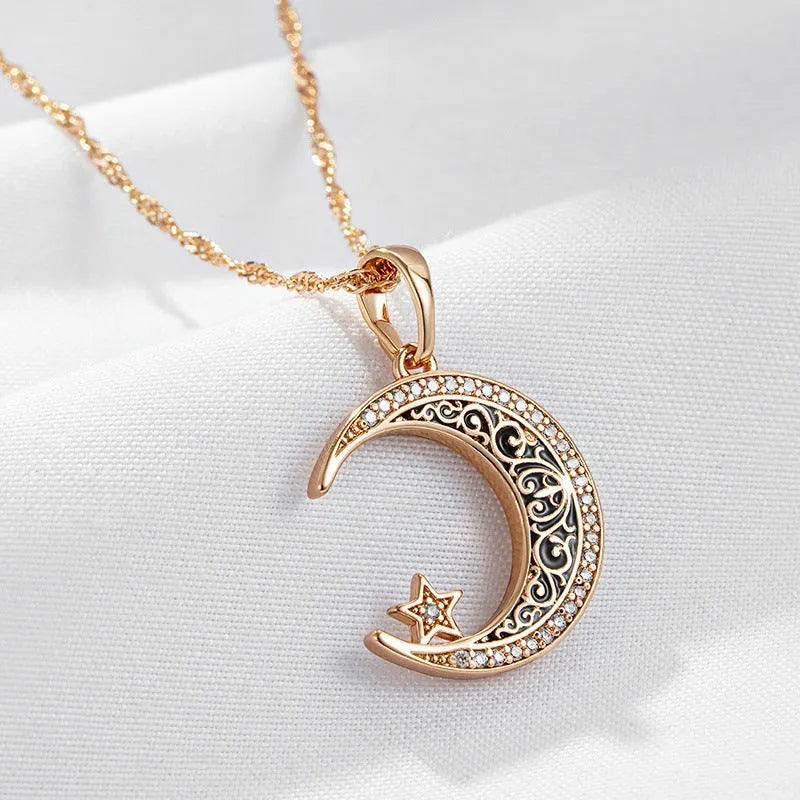 Rose gold star and moon zircon pendant necklace with enamel detail on a water wave chain.