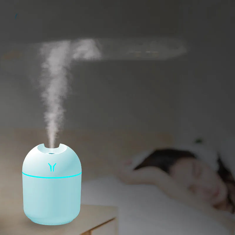 Round desktop humidifier with USB cable in ivory white colour showing mist output