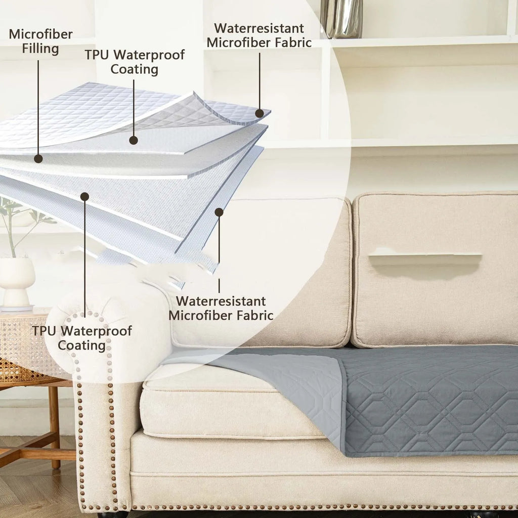 Reversible waterproof dog cushion on a sofa in dark grey and light grey contrast colours.
