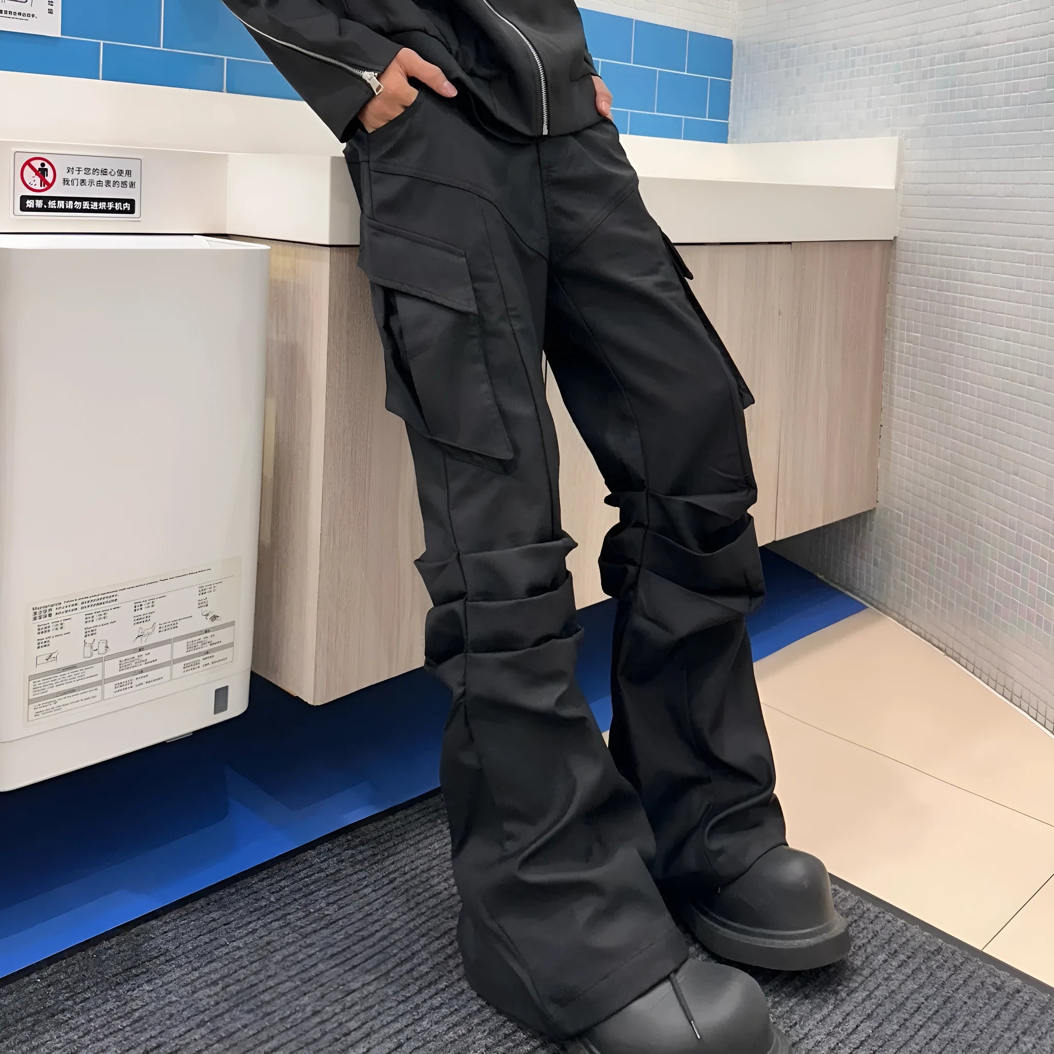 Men's black cargo trousers with large side pockets, straight-leg cut, on a plain background