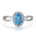 Women's sterling silver jewellery set with blue topaz stones, showing geometric earrings, necklace, ring, and pendant.