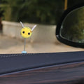 Small, soft, cartoon bee car decoration made from yellow and black fur ball material.