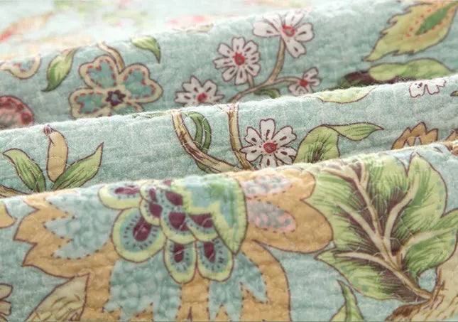Blue American flower and bird pattern cotton bedspread quilted set with three pieces on bed