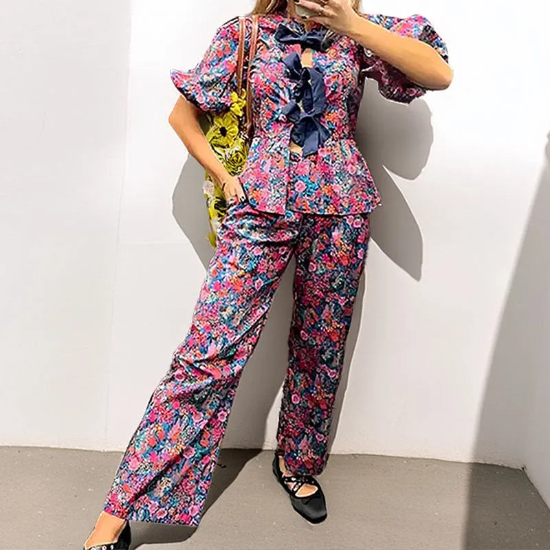 Women's floral print trouser suit with puff sleeve blouse and matching trousers