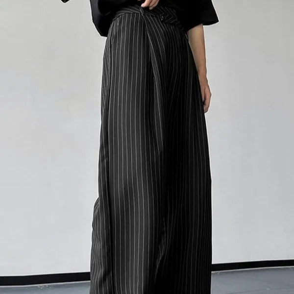 Black men's trousers with vertical stripes and pleated design featuring elastic waistband
