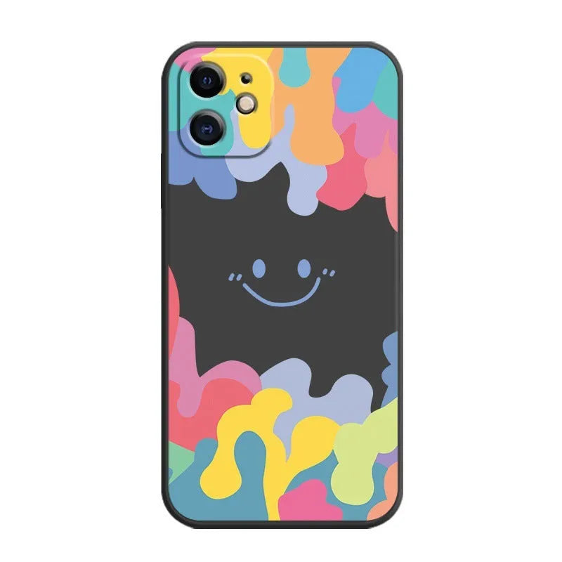 White silicone phone case with a rainbow smiley face design and a black lanyard attached.